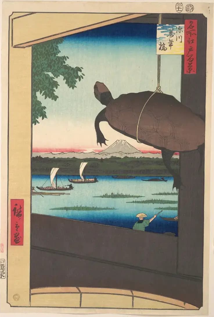 A turtle hangs by a cord beneath a bridge, framing boats, water and distant Mount Fuji