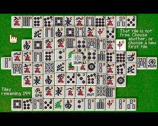 Activision’s Shanghai on Amiga, with the complete Turtle layout on a green background and a message explaining that a selected tile is not free.